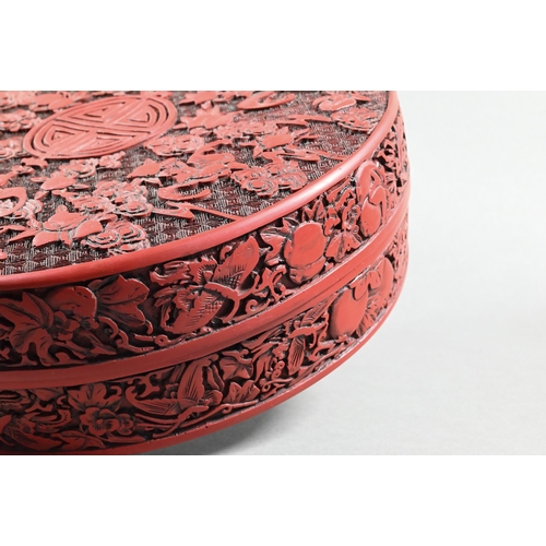 412 - A large Chinese cinnabar lacquer circular box and cover, profusely carved with arrangements of bats,... 