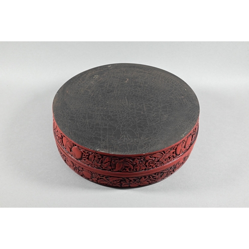 412 - A large Chinese cinnabar lacquer circular box and cover, profusely carved with arrangements of bats,... 