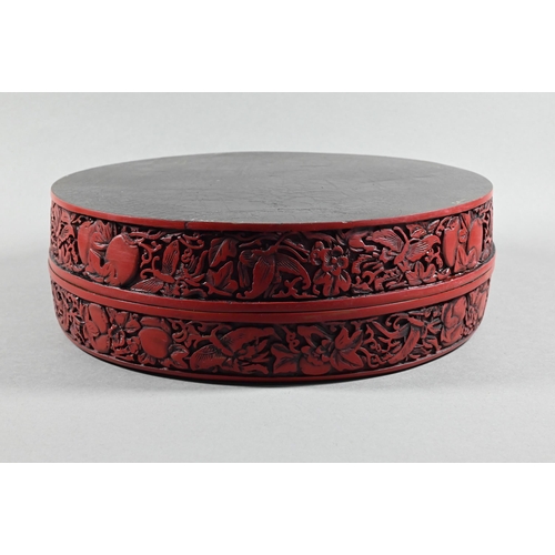 412 - A large Chinese cinnabar lacquer circular box and cover, profusely carved with arrangements of bats,... 