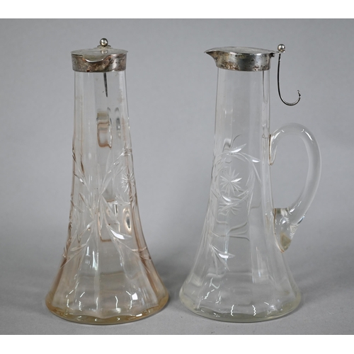 139 - Matched pair of Edwardian cut glass claret jugs with flared bases and silver collars and covers with... 