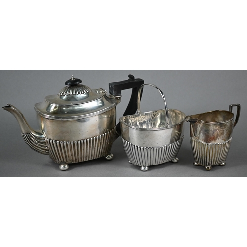 176 - Victorian silver three-piece bachelor tea service of half-fluted oblong form, on bun feet, Martin, H... 