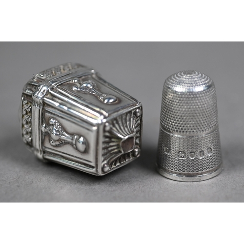 181 - A Victorian thimble-case of square tapering form with embossed decoration, hinged cover with suspens... 