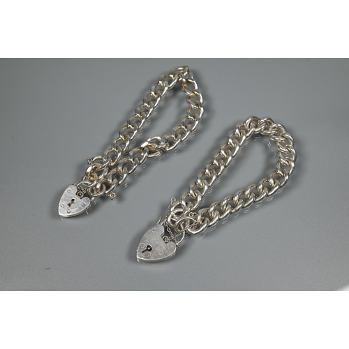 209 - Two modern silver curb bracelets, each fitted with safety chain and padlock, approx 70.3g (2)