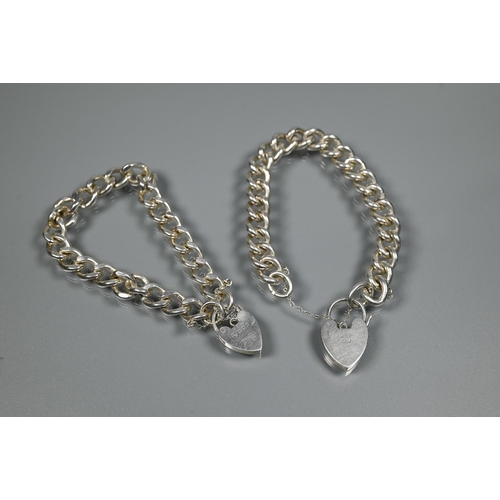 209 - Two modern silver curb bracelets, each fitted with safety chain and padlock, approx 70.3g (2)