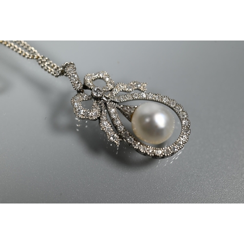 213 - A Belle Epoque diamond and pearl pendant, the old cut diamond-set bow above a tear-shaped diamond se... 