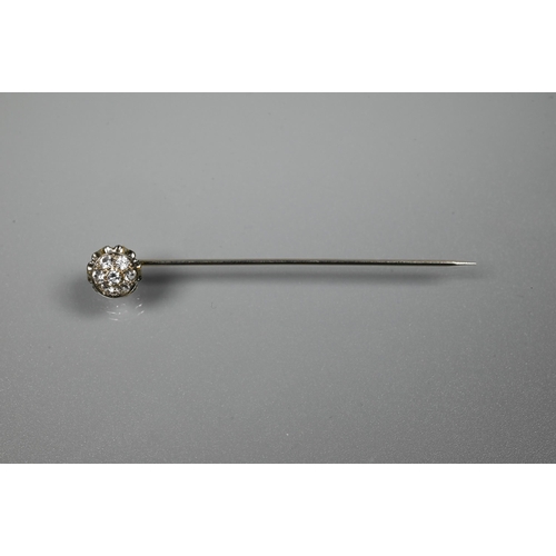 220 - A white metal stick pin set with six white spinel as a cluster, 5.5 cm long