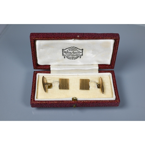 233 - A pair of 9ct chain linked rectangular cufflinks with engine turned decoration and torpedo shaped ba... 