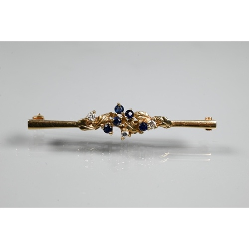 240A - A 9ct yellow gold bar brooch set with sapphires and diamonds in leaf tendril setting, 5 cm long, app... 