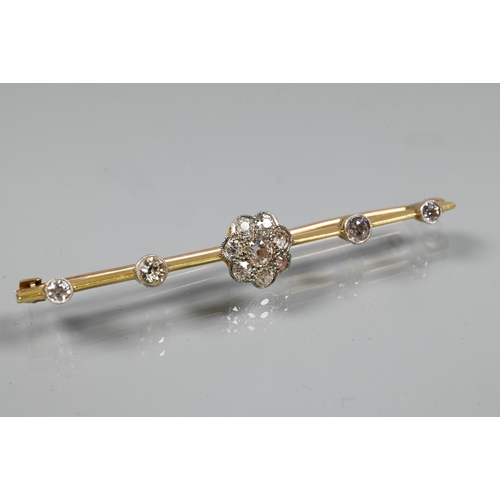 244 - An early 20th century bar brooch featuring a central diamond set daisy cluster, with two further dia... 