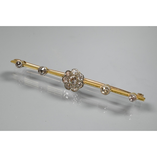 244 - An early 20th century bar brooch featuring a central diamond set daisy cluster, with two further dia... 