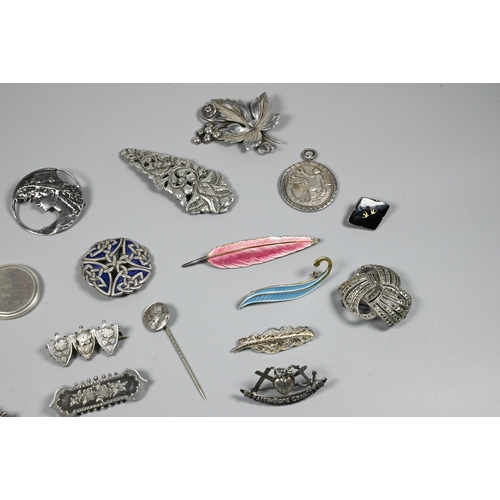 246 - A collection of Victorian and later silver and white metal brooches, pendants and pins including Nor... 