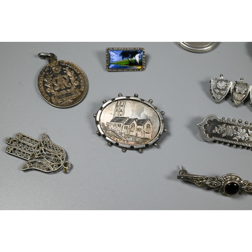 246 - A collection of Victorian and later silver and white metal brooches, pendants and pins including Nor... 