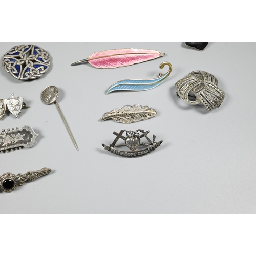 246 - A collection of Victorian and later silver and white metal brooches, pendants and pins including Nor... 