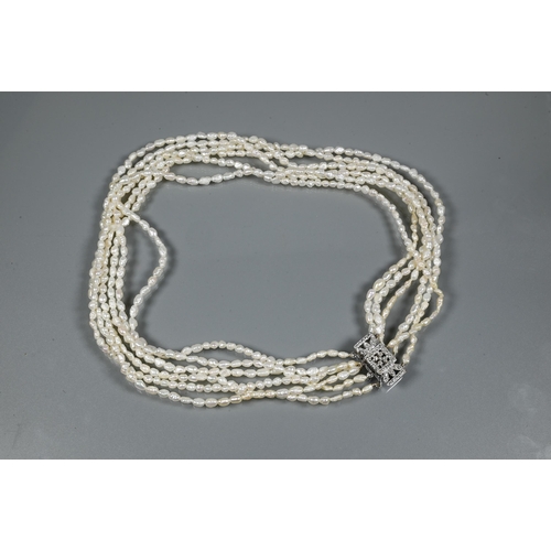 247 - A choker-style necklace formed of six rows of river pearls on to white metal paste-set rectangular c... 