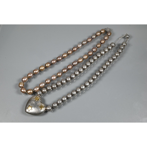 247 - A choker-style necklace formed of six rows of river pearls on to white metal paste-set rectangular c... 