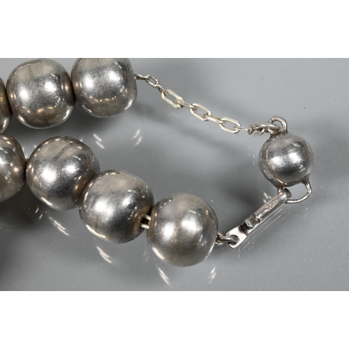 247 - A choker-style necklace formed of six rows of river pearls on to white metal paste-set rectangular c... 