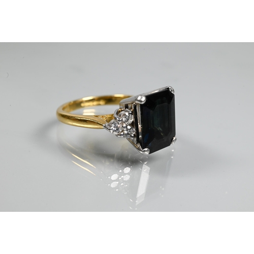 250A - An Art Deco style ring set with rectangular dark blue sapphire (probably), with triple diamond set s... 