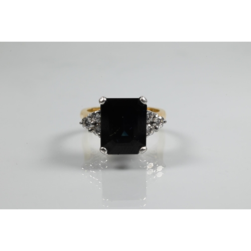 250A - An Art Deco style ring set with rectangular dark blue sapphire (probably), with triple diamond set s... 