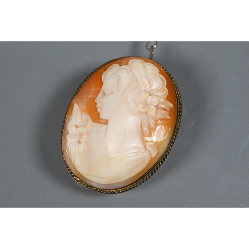 251 - A Continental oval cameo brooch featuring a young lady, in white metal rope edged mount, fitted with... 