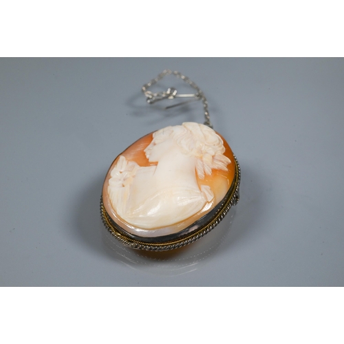 251 - A Continental oval cameo brooch featuring a young lady, in white metal rope edged mount, fitted with... 