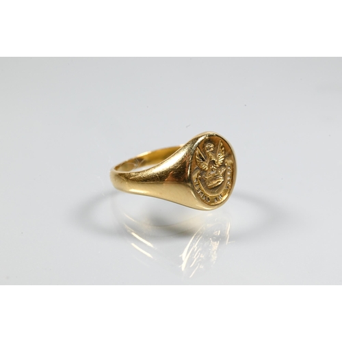 255 - An unmarked yellow metal signet ring with intaglio crest, size I, approx 2.7g