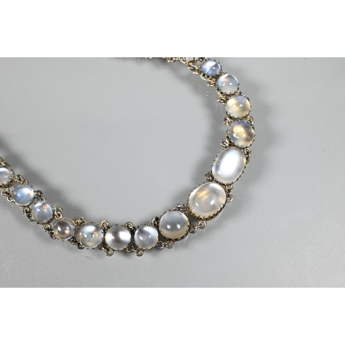 262 - An Arts & Crafts style choker necklace set with thirty-three graduated cabochon moonstones, in c... 