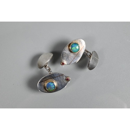 266 - A pair of contemporary silver 'Eye' cufflinks inlaid with rose-coloured 9ct gold and set with double... 