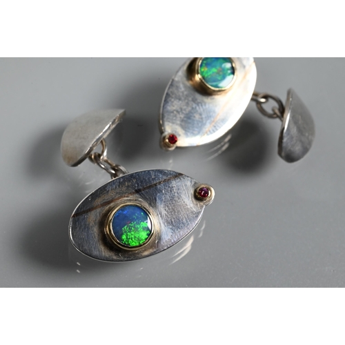 266 - A pair of contemporary silver 'Eye' cufflinks inlaid with rose-coloured 9ct gold and set with double... 