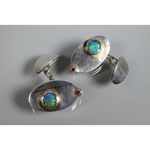 266 - A pair of contemporary silver 'Eye' cufflinks inlaid with rose-coloured 9ct gold and set with double... 