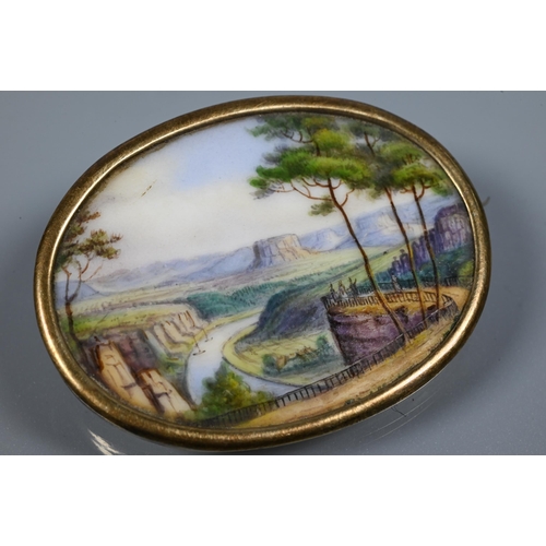 270 - An oval painted porcelain plaque featuring classical Italianate landscape, with brooch fitting, 3.8 ... 