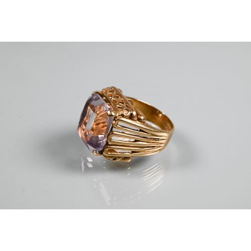 270A - A 9ct yellow gold ring set large rectangular quartz, in high cage-style setting with open ribbed sho... 