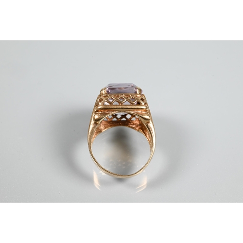 270A - A 9ct yellow gold ring set large rectangular quartz, in high cage-style setting with open ribbed sho... 