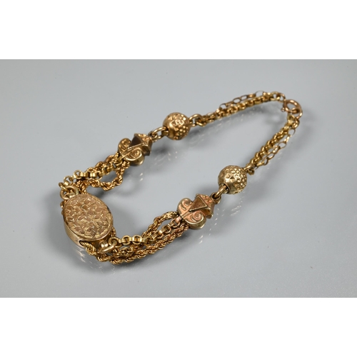 272 - A Victorian 9ct rose gold bracelet formed of three chains linked by balls, and oval foliate engraved... 