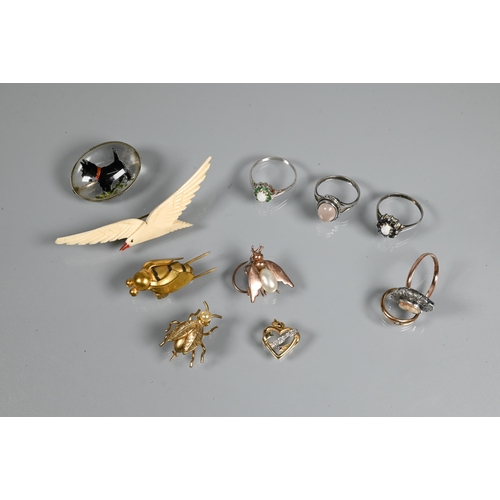 274 - Five various stone set rings, including one diamond, a lucite oval brooch featuring reverse carved b... 