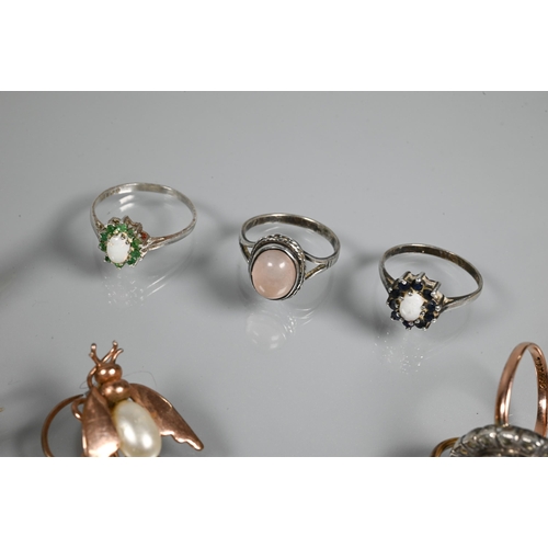 274 - Five various stone set rings, including one diamond, a lucite oval brooch featuring reverse carved b... 