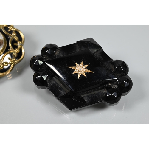 279 - Two Victorian mourning brooches - a diamond-shaped jet brooch with inset gold star motif with seed p... 