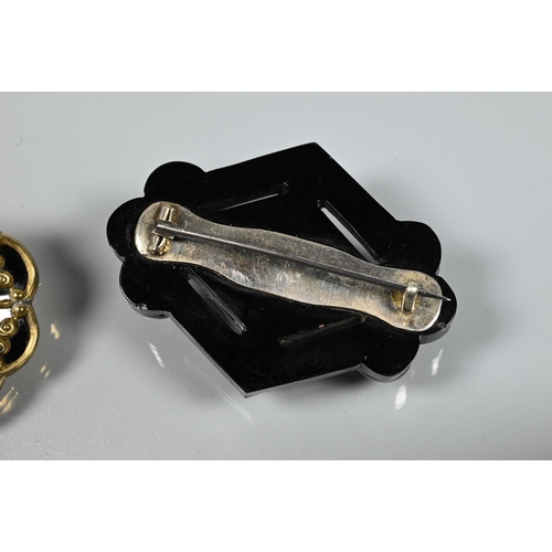 279 - Two Victorian mourning brooches - a diamond-shaped jet brooch with inset gold star motif with seed p... 