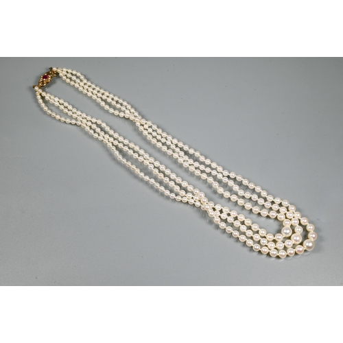 280A - A triple row of graduated cultured pearls double knotted throughout onto ruby and pearl set snap, 9c... 