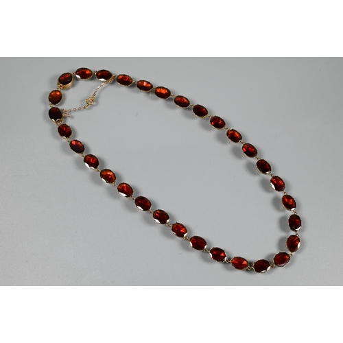 289 - A Victorian oval garnet set necklace in 9ct yellow gold closed back setting, concealed clasp with sa... 