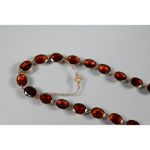 289 - A Victorian oval garnet set necklace in 9ct yellow gold closed back setting, concealed clasp with sa... 