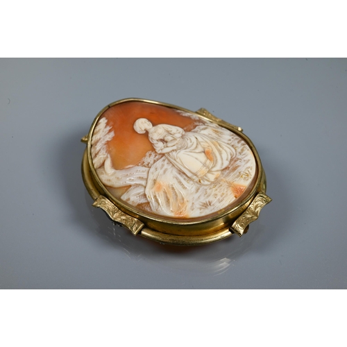 294 - A large Victorian carved shell cameo brooch featuring maiden seated in a landscape, yellow metal mou... 