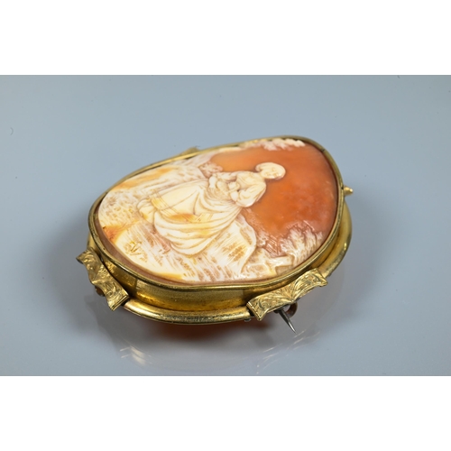 294 - A large Victorian carved shell cameo brooch featuring maiden seated in a landscape, yellow metal mou... 