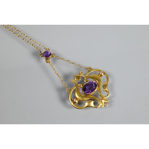 301 - An Art Nouveau pendant, the 9ct yellow gold open scroll design with central oval shaped amethyst, su... 