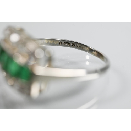 310 - An emerald and diamond three row Art Deco style ring, the central row with five graduated baguette c... 