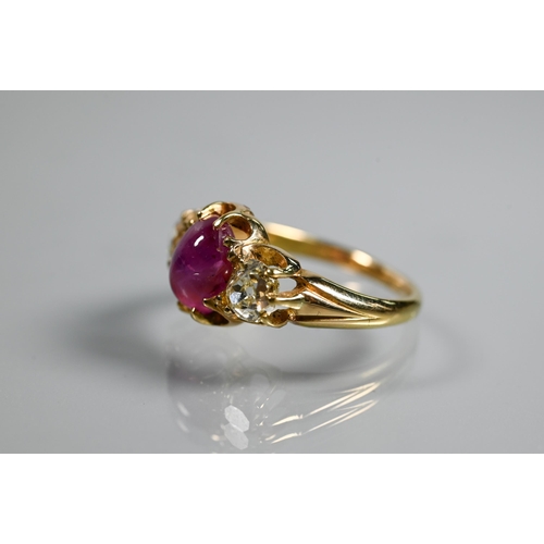 311 - A three stone ring, the central oval cabochon ruby with circular diamond to each side, claw set, unm... 