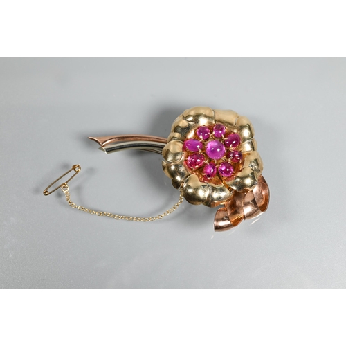 316 - A floral spray brooch of pink, yellow and white unmarked metal set with nine pink sapphire/ruby cabo... 