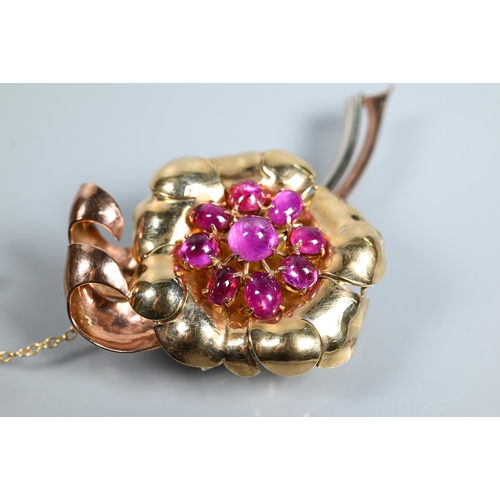 316 - A floral spray brooch of pink, yellow and white unmarked metal set with nine pink sapphire/ruby cabo... 