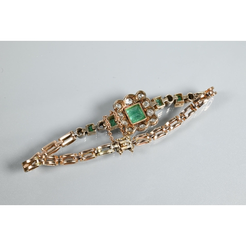 318 - An emerald and diamond cluster bracelet, the central rectangular baguette cut emerald surrounded by ... 