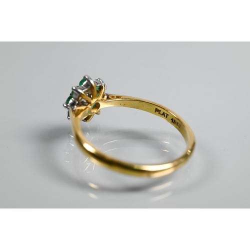 322 - An emerald and diamond daisy ring, the central diamond surrounded by eight small emeralds, yellow an... 