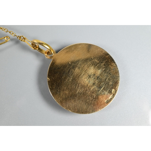 323 - A circular yellow metal pendant disc featuring a naturalistically detailed crab in relief on engine ... 